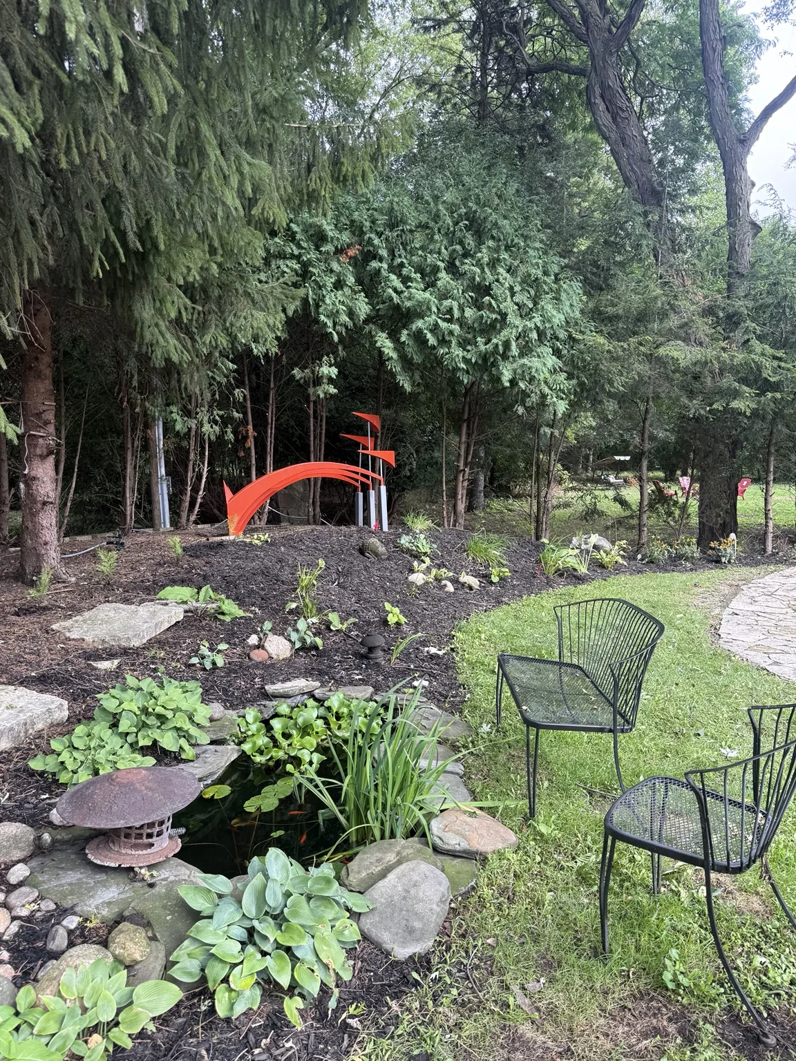 Backyard pond and fresh landscaped bed
